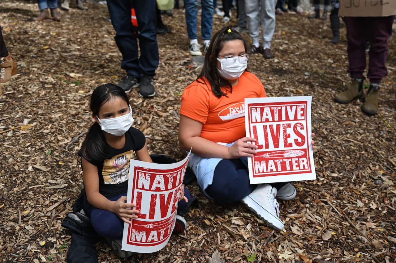 Two people hold placards during the demonstration in central Montreal.