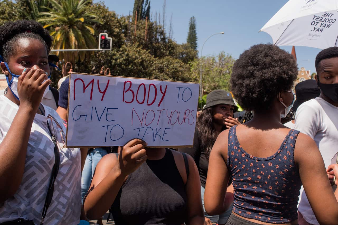 A protester holds a placard during the second day of the #ShutItDown protests in Windhoek, Namibia, on 9 October 9, 2020.