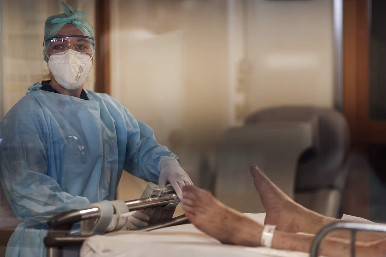 A medical worker tends to a patient at the intensive care unit for COVID-19 patients at The University Hospital Centre in Liege on 22 October.