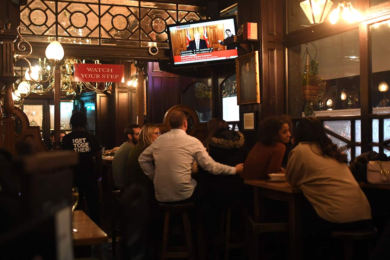 Punters at the Red Lion Pub in Westminster watch as UK Prime Minister Boris Johnson announces a four week England lockdown on 31 October.