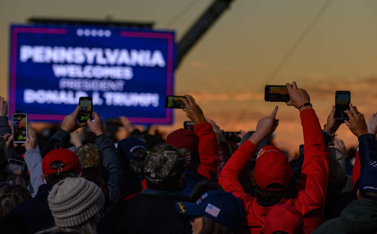 Supporters listen as President Donald Trump speaks at a campaign rally at Pittsburgh-Butler Regional Airport on 31 October in Butler, Pennsylvania.