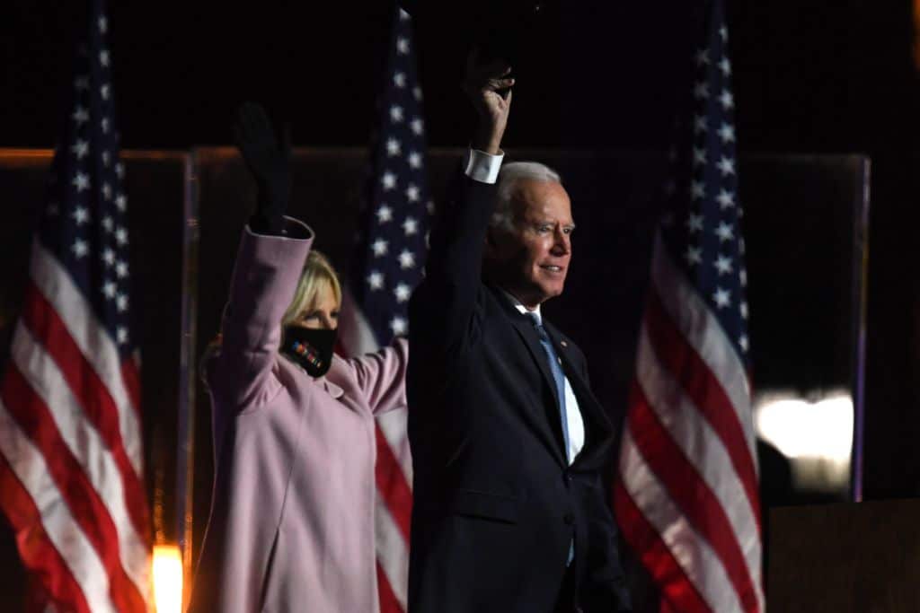 Democratic presidential nominee Joe Biden (R) and wife Jill Biden address supporters during election night at the Chase Center in Wilmington, Delaware. 