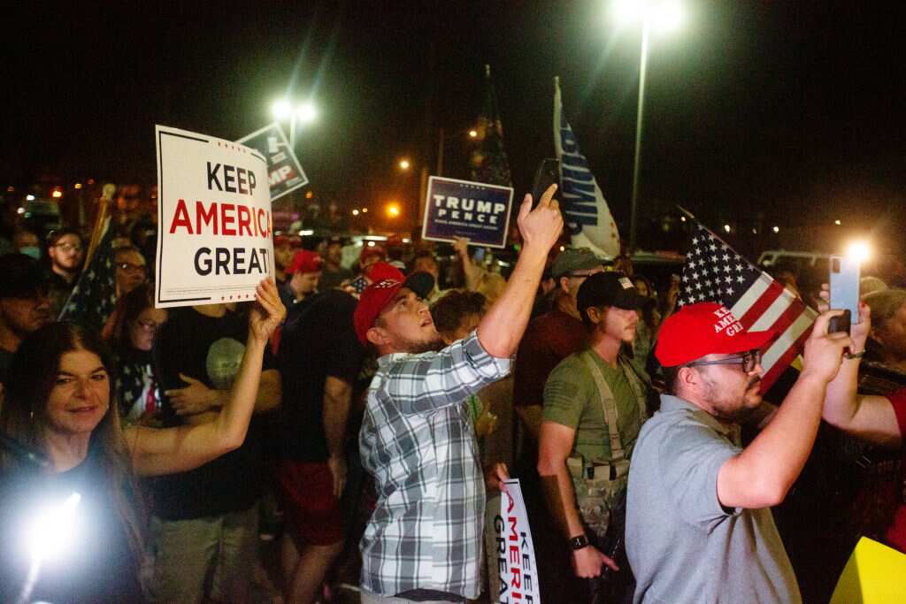 Protesters in support of President Donald Trump gather to protest the election results at the Maricopa County Elections Department office.