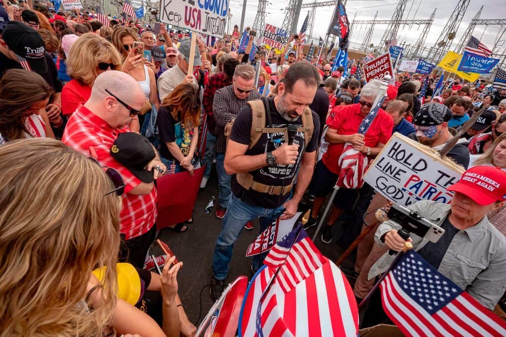 President Trump supporters pray in front of  the Maricopa County Election Department while votes are being counted in Phoenix, Arizona.