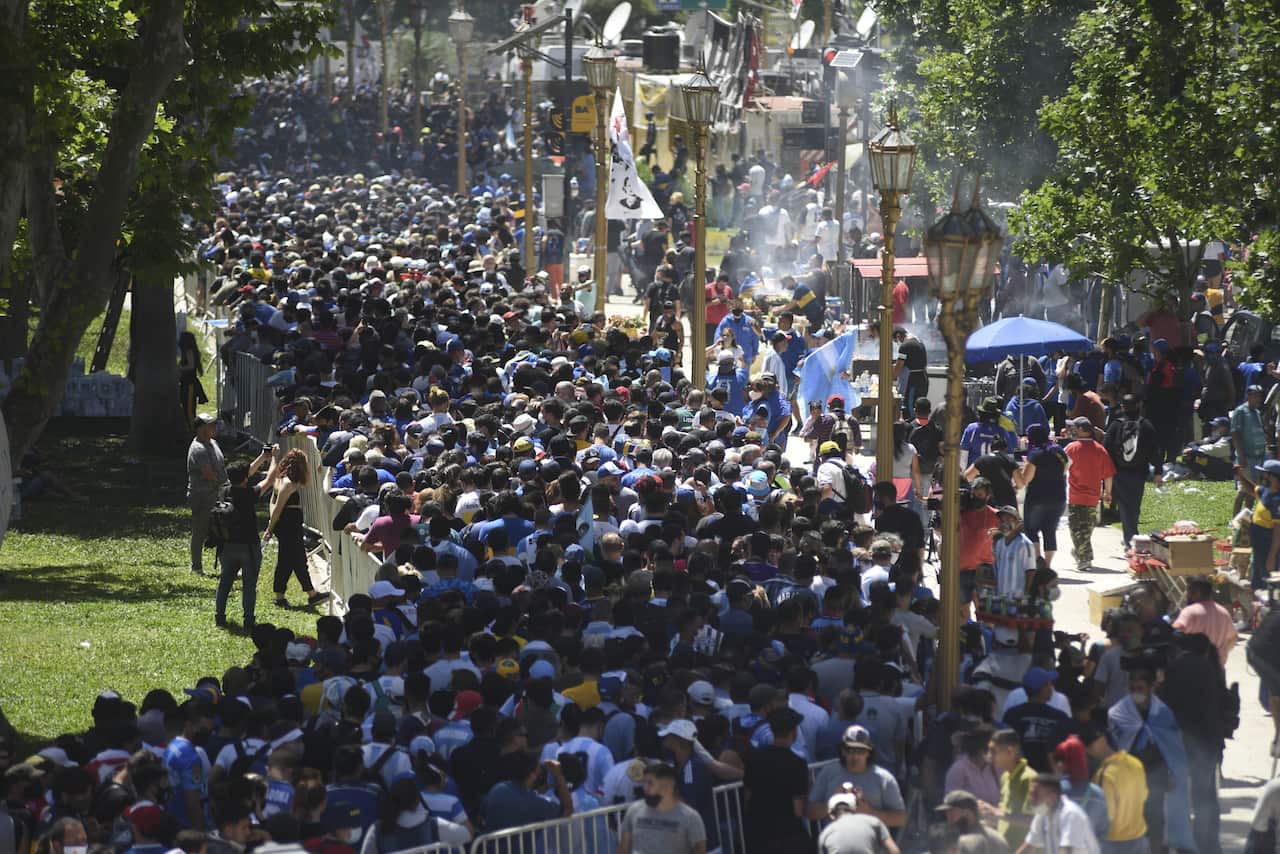 People gathered  in front of the Casa Rosada building to attend the funeral ceremony of Diego Armando Maradona in Buenos Aires, Argentina.
