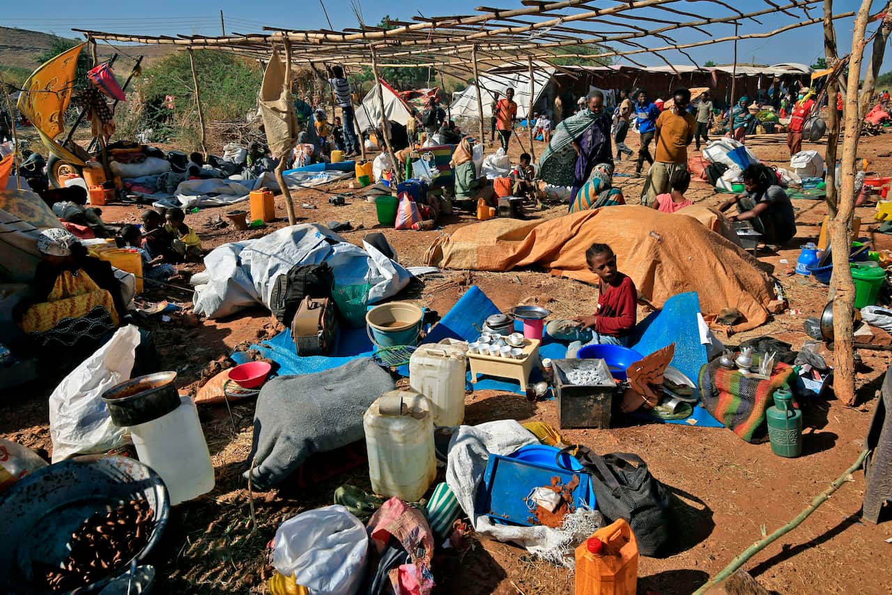 Ethiopian refugees who fled the Tigray conflict, start building temporary huts at Um Raquba camp in Sudan's eastern Gedaref province.