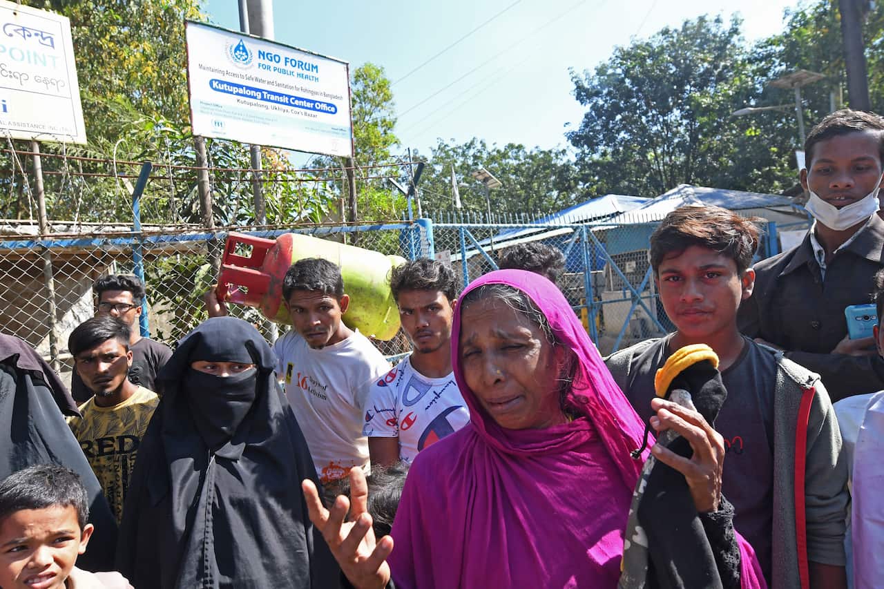 Relatives of Rohingya refugees gather outside the transit camp before the start of relocation of refugees.