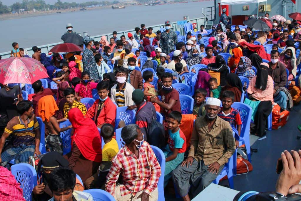 Rohingya refugees board a Bangladesh Navy ship to be transported to the island of Bhashan Char in Chittagong on 4 December.