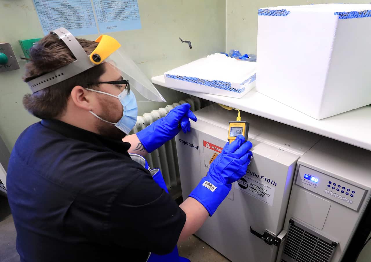 A pharmacy technician takes delivery of the first batch of COVID-19 vaccinations at Croydon University Hospital in south London on 5 December, 2020.