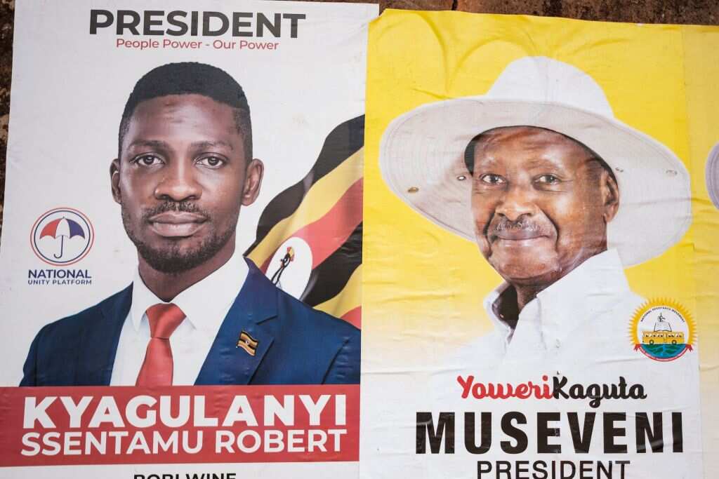 The posters of two most popular candidates for Uganda's presidential election, incumbent Yoweri Museveni (R) and Bobi Wine (L)
