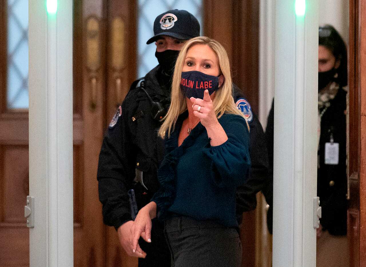 Representative Marjorie Taylor Greene shouts at journalists as she goes through security outside the House Chamber at Capitol Hill in Washington, 12 January.