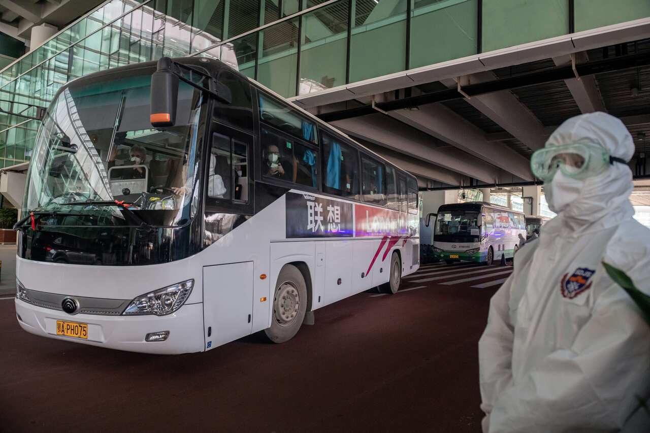 A bus carrying members of the WHO team leaves the airport following their arrival in Wuhan on 14 January. 