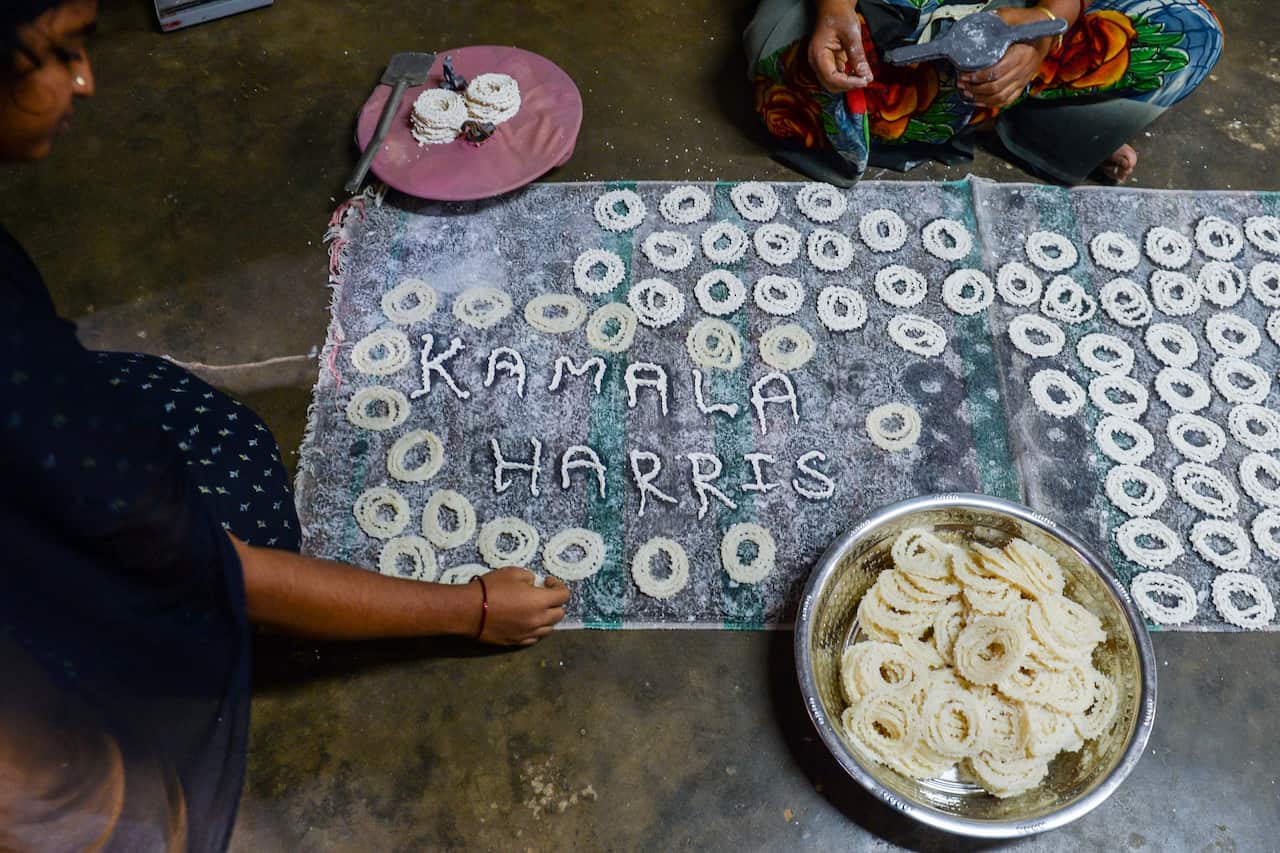 Women make a traditional snack to celebrate the inauguration of US Vice President-elect Kamala Harris.