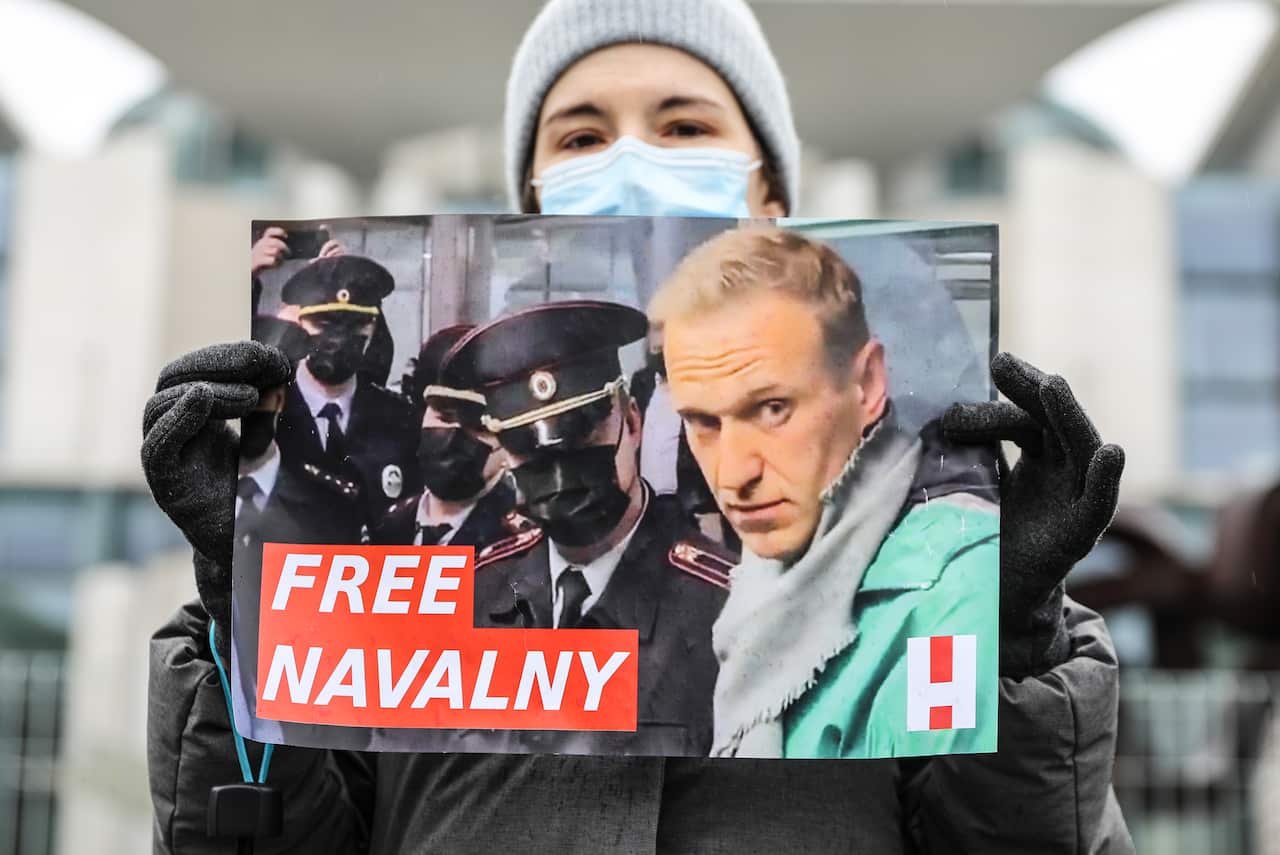 A protester holds a banner reading "FREE NAVALNY" at a January rally demanding his release from prison in Berlin, Germany.