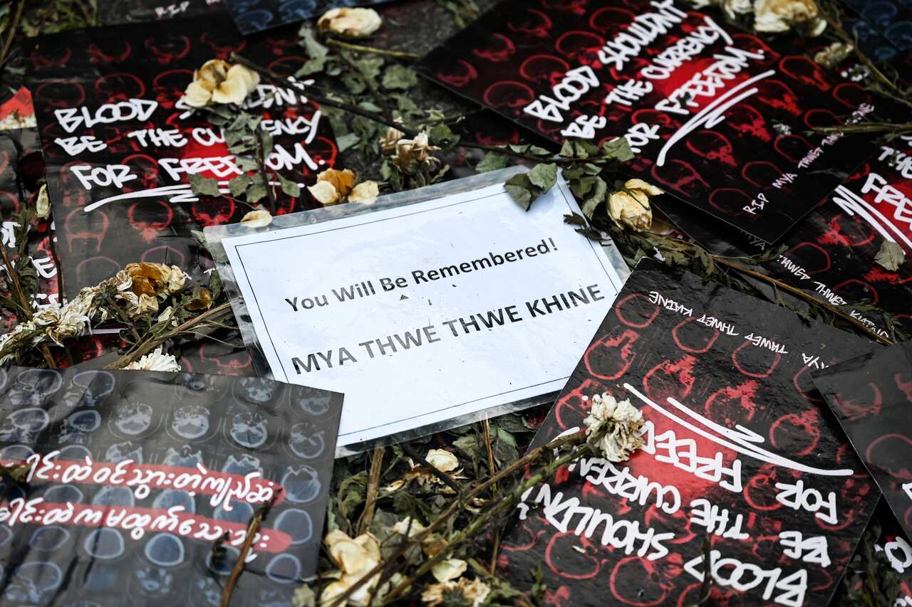 Flowers and sympathy messages are placed on the ground in honor of Mya Thwate Thwate Khaing during a demonstration in Yangon on 29 February.