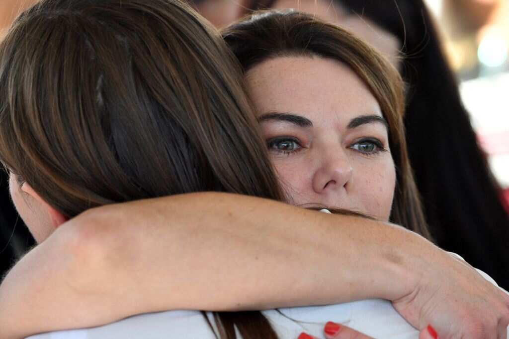 Greens senator Sarah Hanson-Young (R) hugs former government staffer Brittany Higgins (L) during the rally in front of Parliament House on 15 March, 2021. 