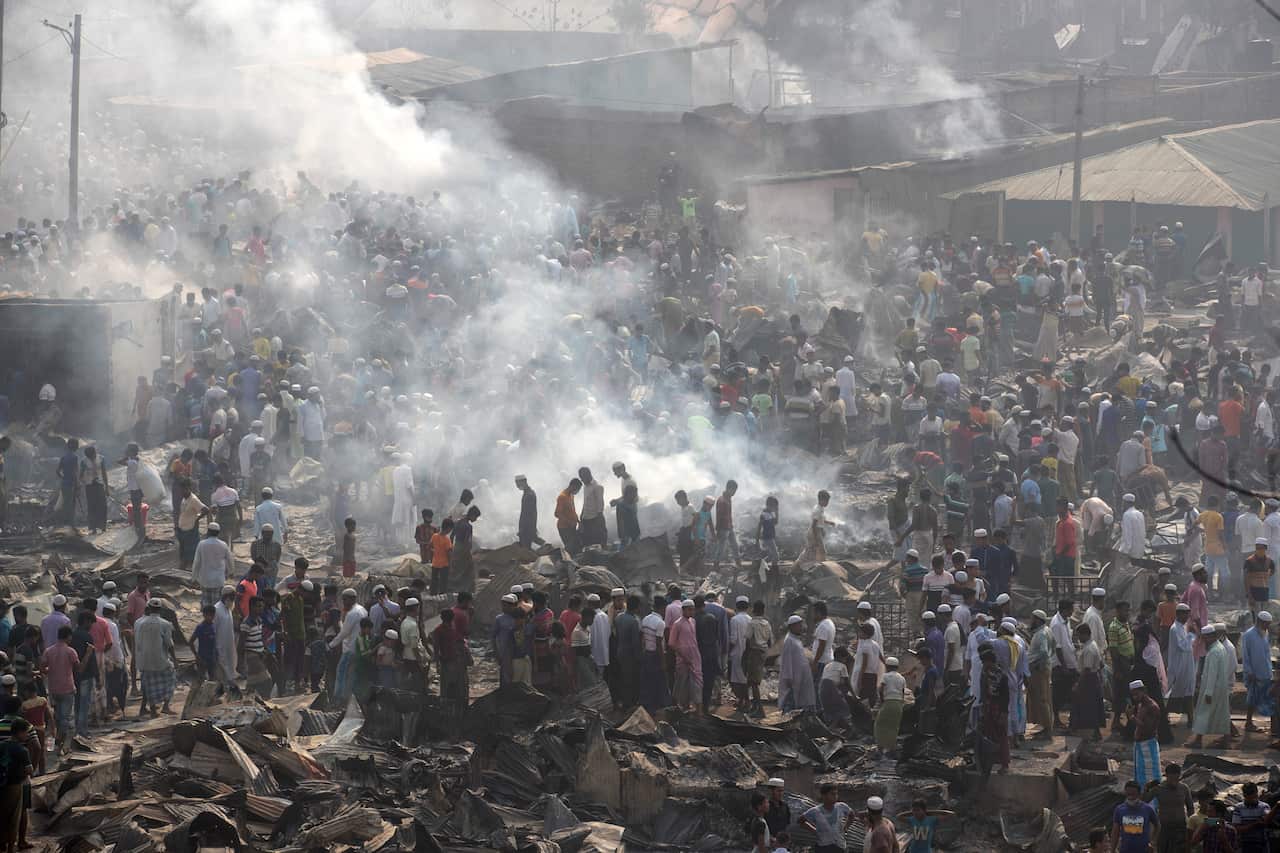 Rohingya refugees search for their belongings after a fire broke out at the Balukhali Rohingya refugee camp, Cox's Bazar. 
