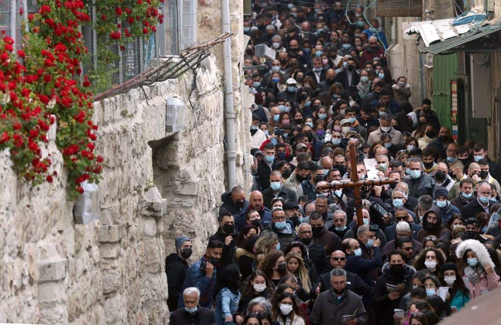 Christian worshippers carry a wooden cross in Jerusalem's Old City during the Good Friday procession.