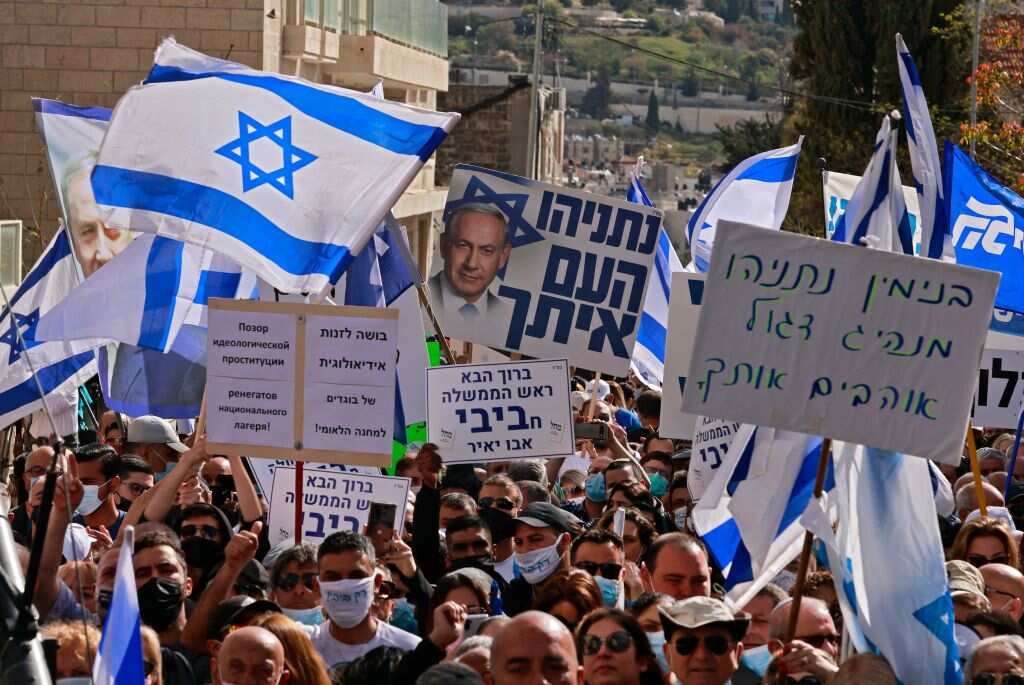 Supporters of Prime Minister Benjamin Netanyahu gather outside the district court in Jerusalem on 5 April 2021 ahead of Prime Minister's corruption trial.