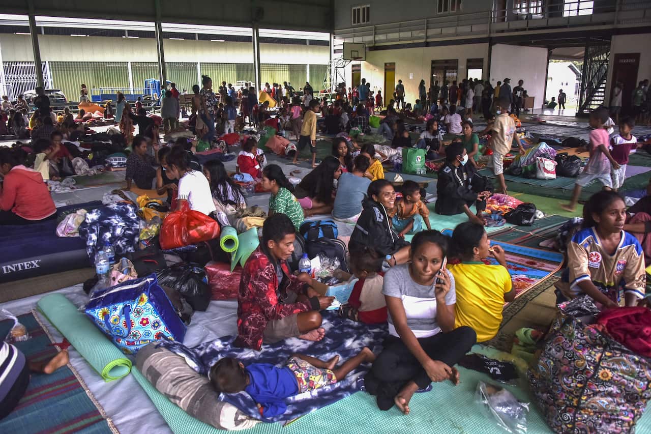 Residents take refuge at an evacuation centre after torrential rains triggered floods and landslides, damaging their homes in Dili on 5 April. 