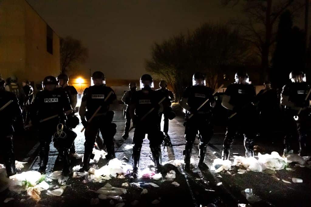 Police officers stand in line in front of the Brooklyn Center Police Station