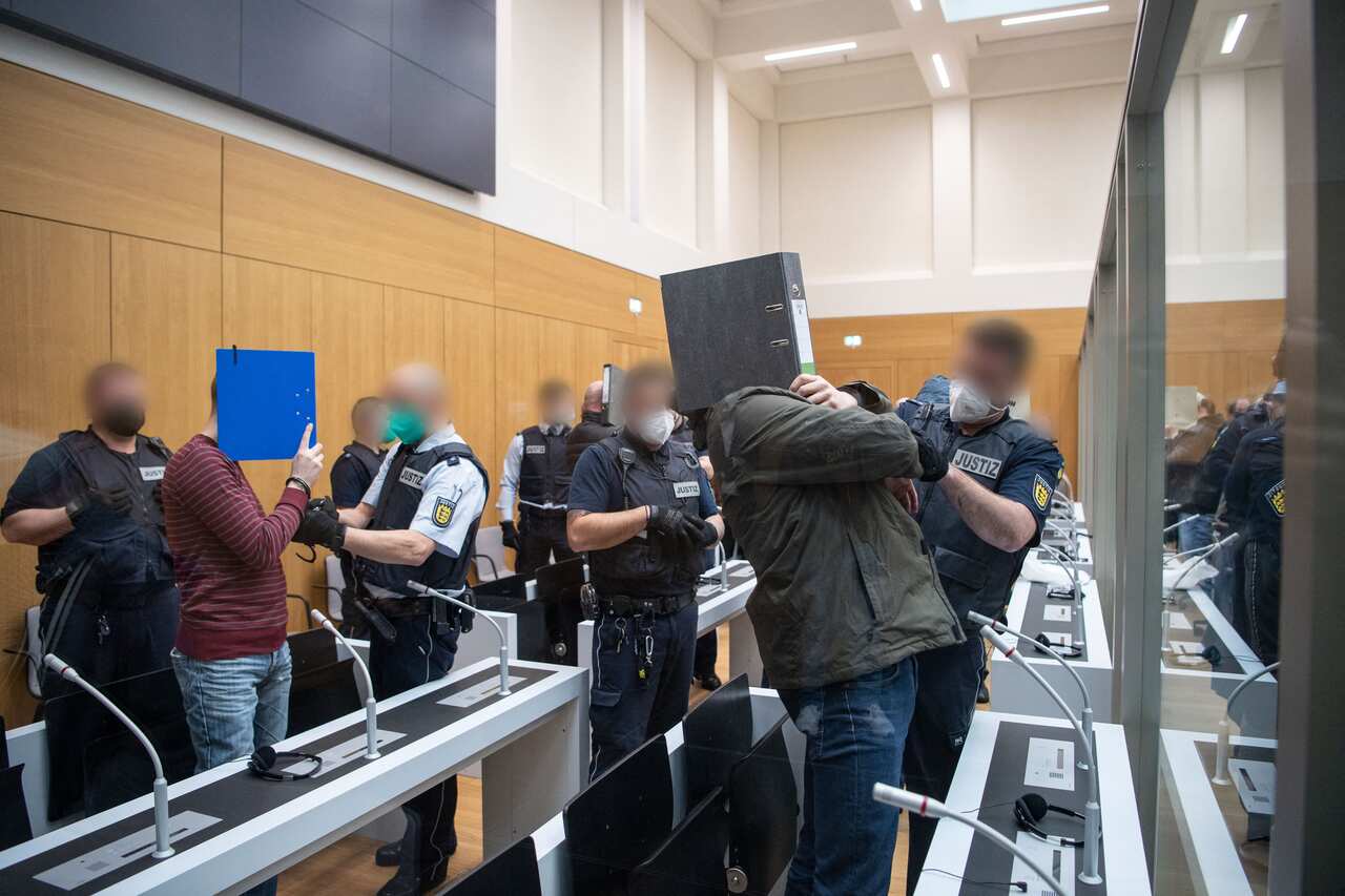 Defendants are escorted by justice officers for the opening of the trial of twelve men accused of building and supporting a terrorist organisation in Germany.