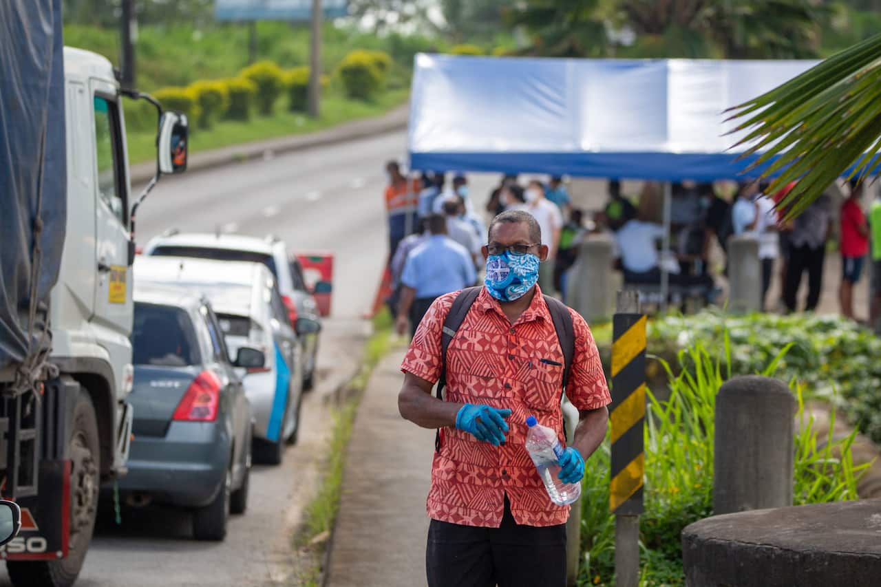 Security officers checking cars along a road in Suva after the Fijian capital entered a 14-day lockdown on 26 April, 2021.