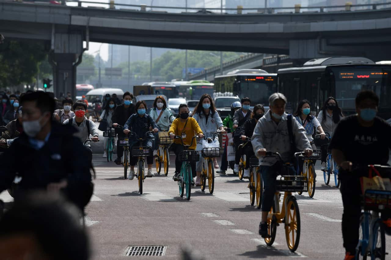 Commuters are seen riding during morning rush hour in Beijing on 11 May, 2021.