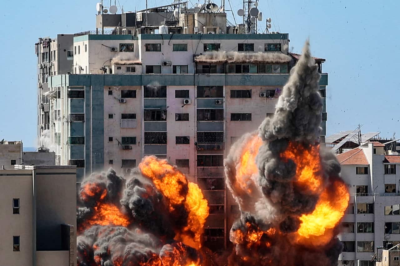 A ball of fire erupts from the Jala Tower as it is destroyed in an Israeli airstrike in Gaza City on 15 May, 2021. 