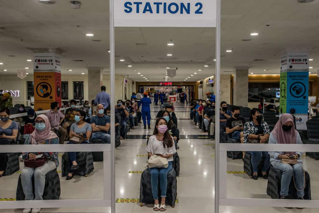 People queue to receive the AstraZeneca vaccine as part of a mass vaccination program in Kuala Lumpur (16 May 2021).