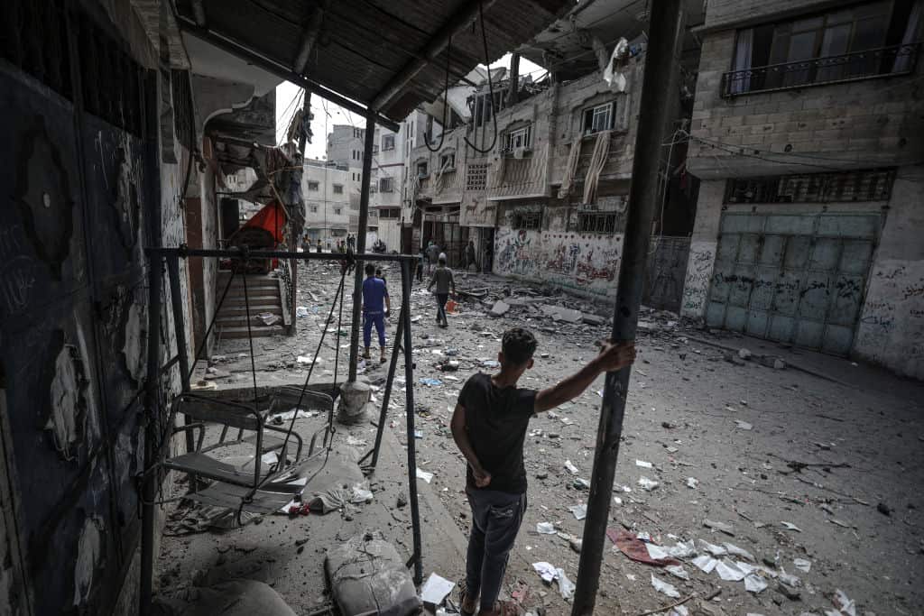Palestinians inspect damaged building after airstrikes by Israeli army hit buildings in Gaza City, Gaza.