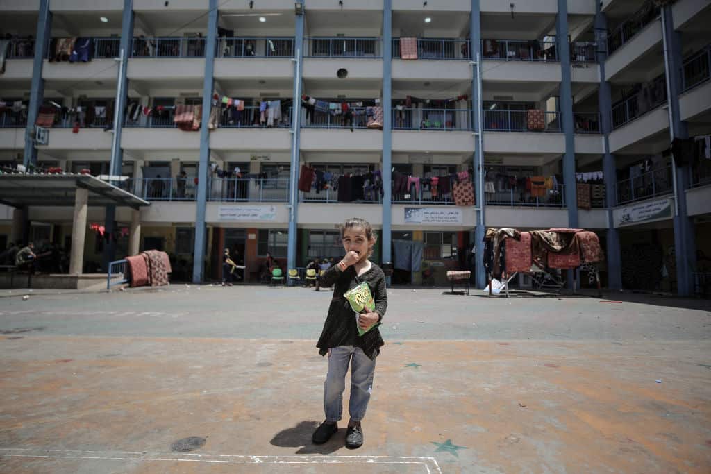 Palestinian children who had been displaced with their families in the Gaza Strip due to Israeli attacks on the area shelter in El Jadida school, in Gaza City.