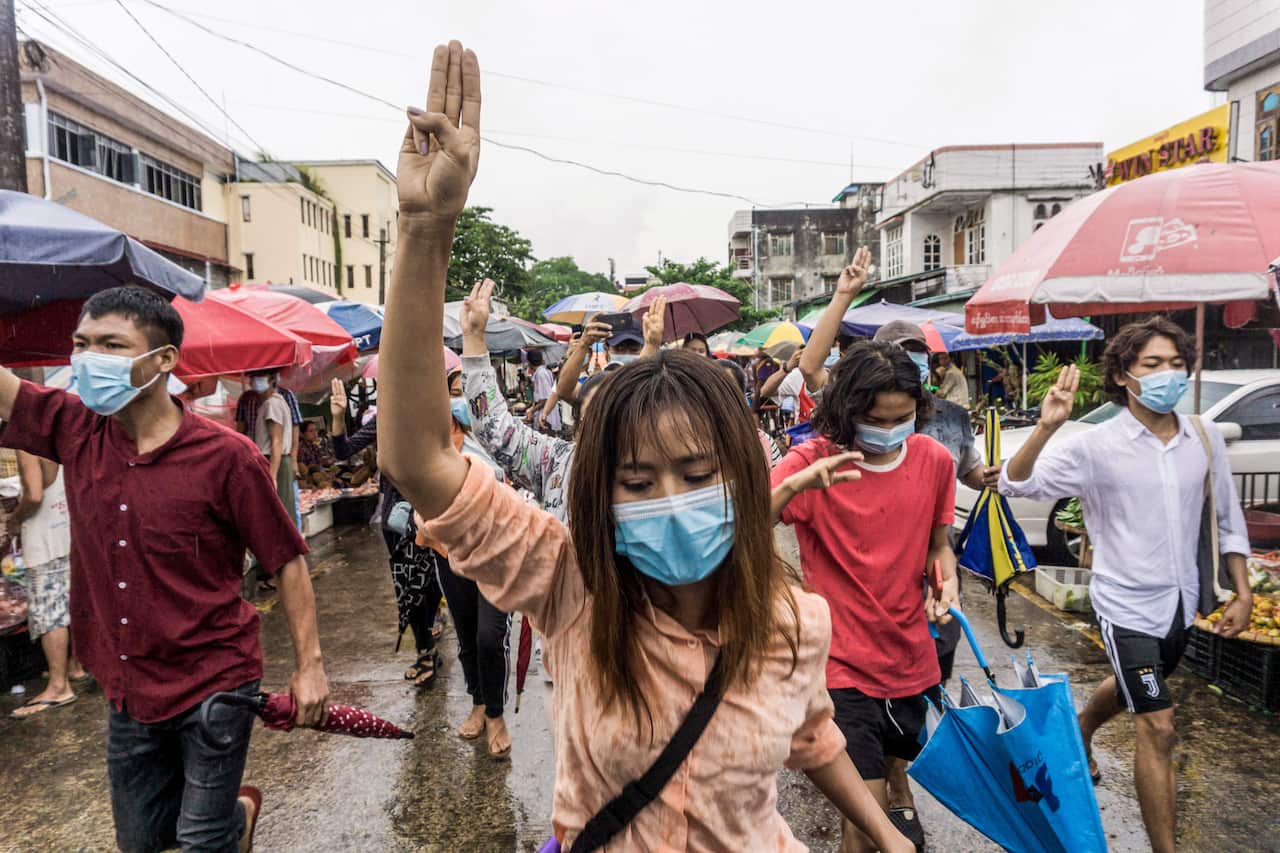 Protesters make the three-finger salute during a demonstration against the military coup in Yangon, Myanmar, on 21 May, 2021. 