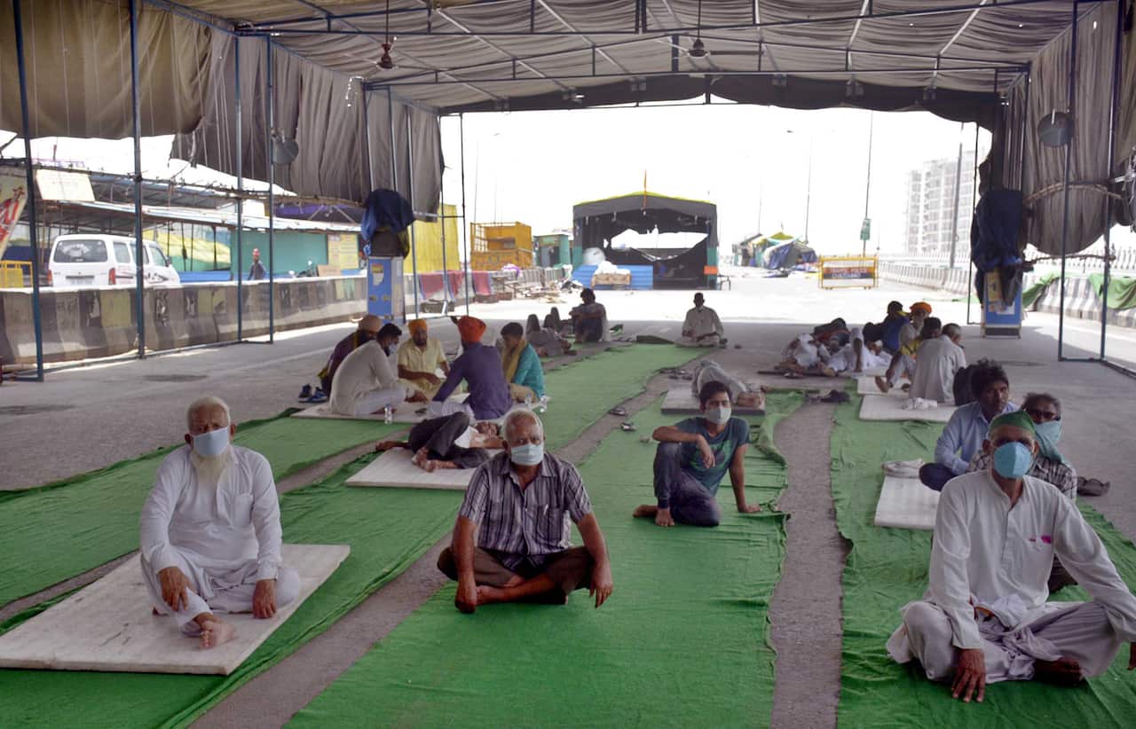 Farmers sitting distantly at the border of Delhi and Uttar Pradesh in Ghaziabad, India during the ongoing protest against the three new farm laws on 23 May 2021.