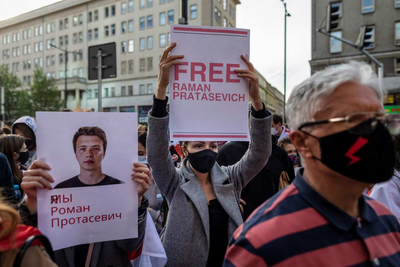Belarusians living in Poland and Poles supporting them hold up a placard reading 'Free Roman Protasevich' during a demonstration in front of the European Commission office in Warsaw on 24 May 2021.