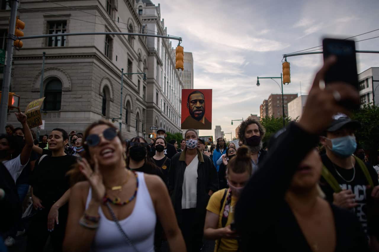 Black Lives Matter protesters march on the anniversary of the death of George Floyd, in Brooklyn, New York on 25 May, 2021.