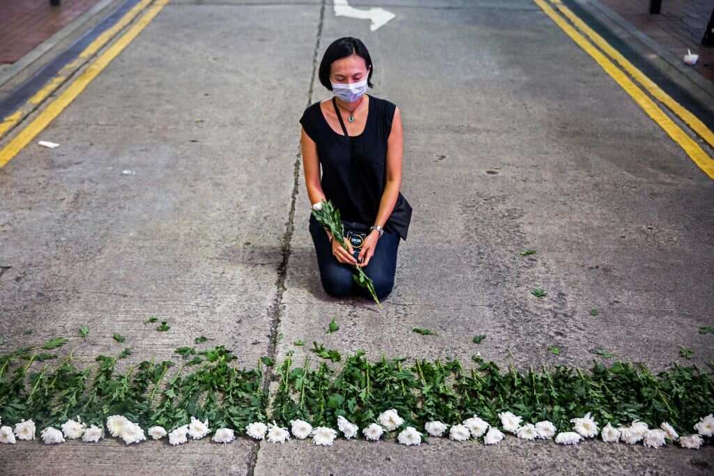 An artist takes part in a performance art in the Causeway Bay district of Hong Kong on 3 June, 2021, to mourn the victims of China's Tiananmen Square crackdown.