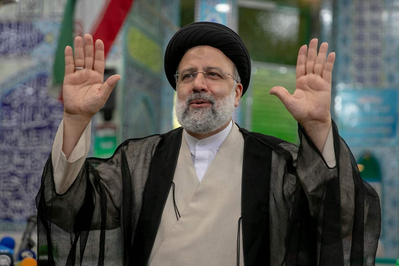 Ebrahim Raisi, a candidate in Iran's presidential elections, waves to the media after casting his vote at a polling station on 18 June, 2021.