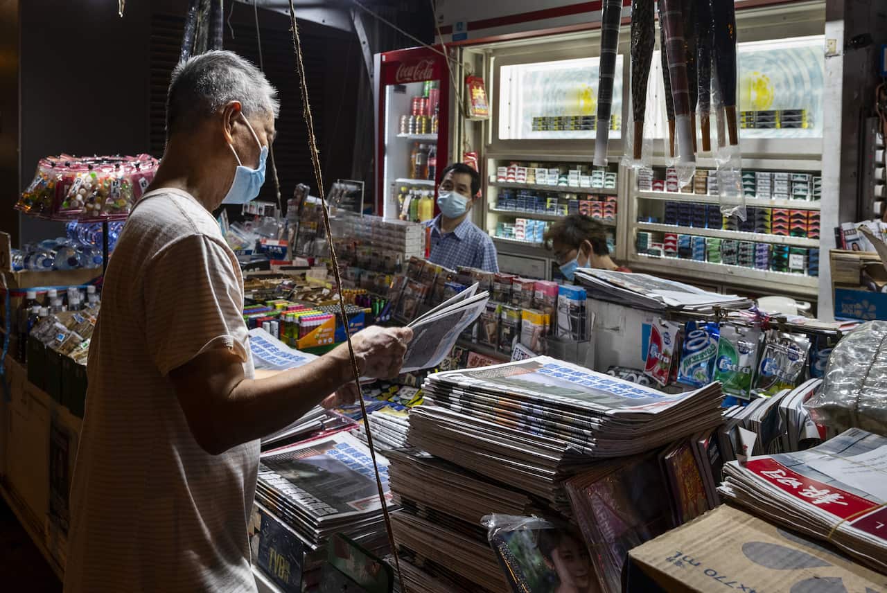 A man purchases a copy of Apple Daily newspaper at a newsstand in Hong Kong on 22 June, 2021.