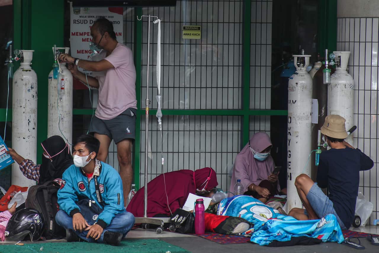 COVID-19 patients receive treatment outside the emergency room of a hospital in Surabaya, East Java, on 11 July, 2021. 