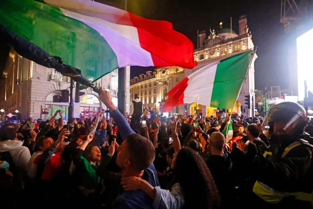 Italy supporters celebrate their team's victory at Piccadilly Circus after the EURO 2020 final football match between England and Italy, in London. 