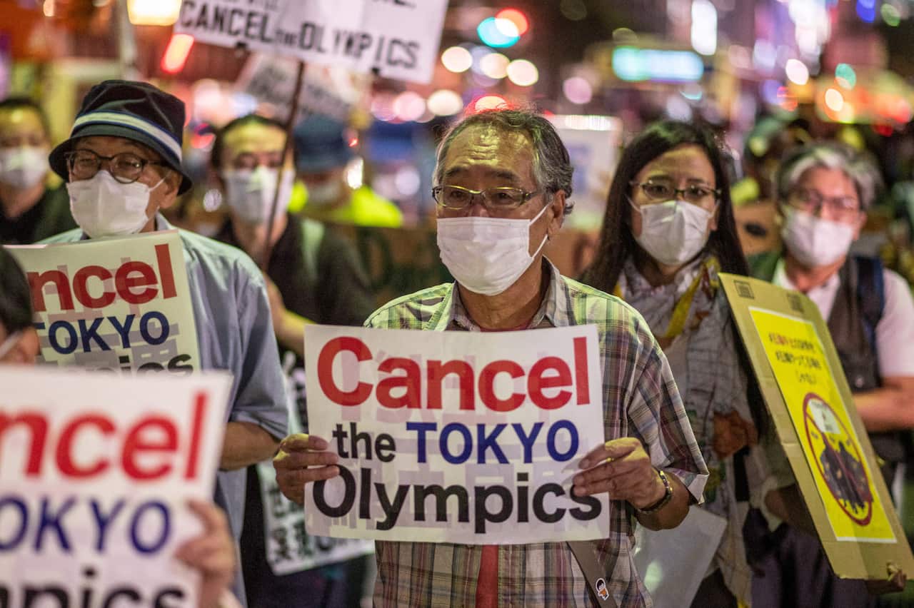 Activists march to the offices of the Olympic Games  organising committee in Tokyo on 16 July.