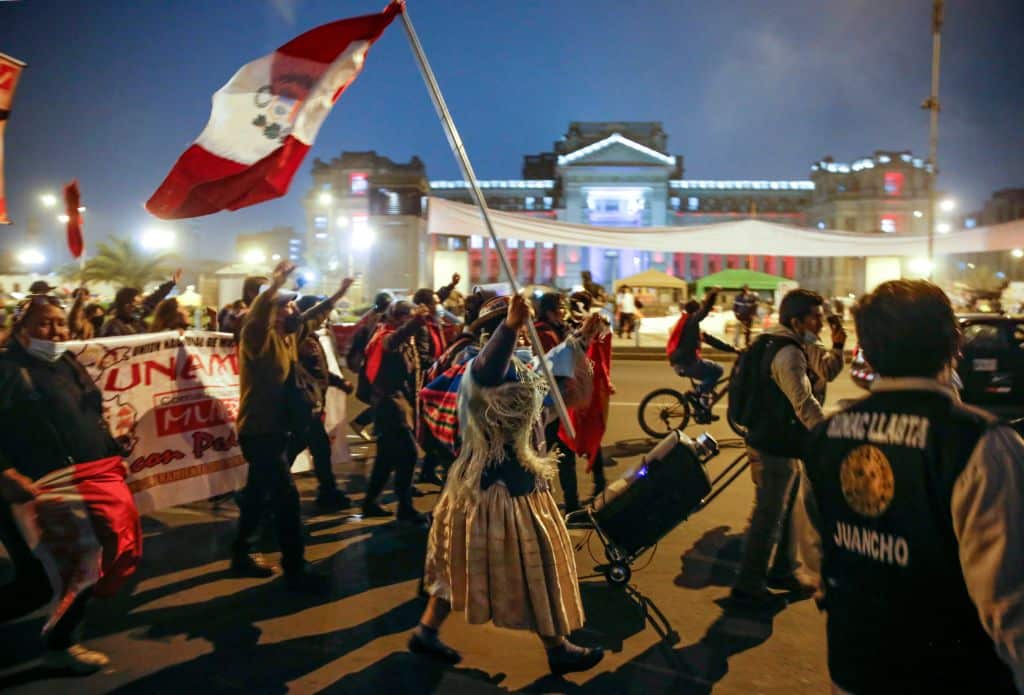 Supporters of leftist school teacher Pedro Castillo celebrate in downtown Lima following the official proclamation of him as Perus president-elect. 