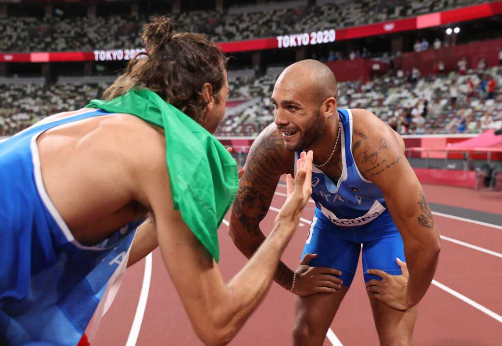 Italy's Lamont Marcell Jacobs is congratulated by fellow countrymen Gianmarco Tamberi after winning the men's 100m final during the Tokyo 2020 Olympic Games.