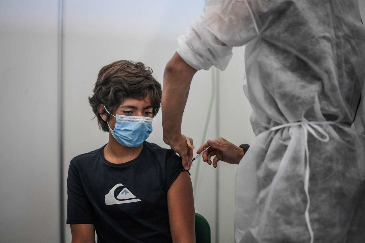 Diogo, 13 years old, is vaccinated against COVID-19 by a soldier at a vaccination center in Lisbon, on September 11, 2021.