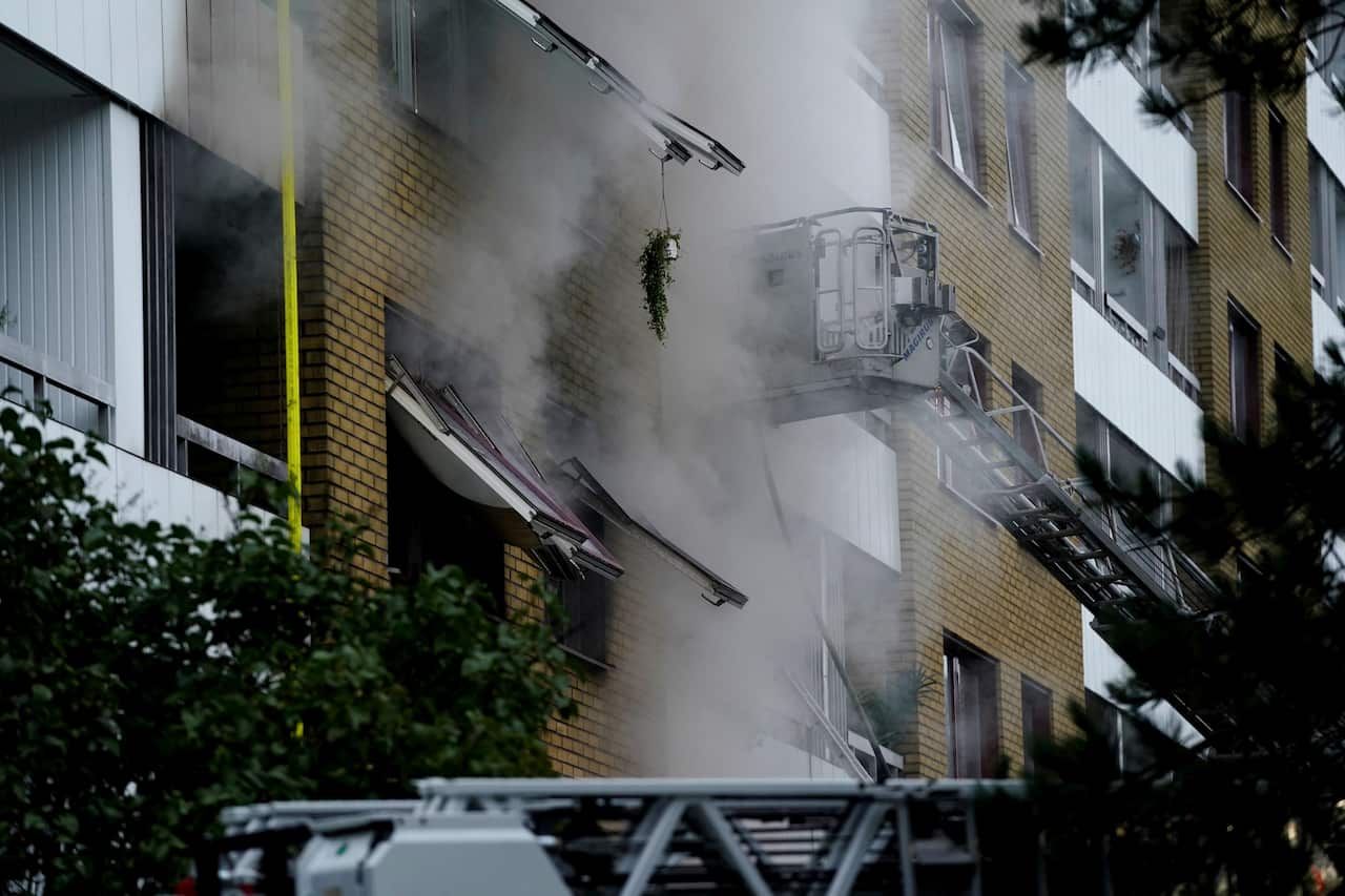 Smoke billows from a building as emergency services fights a fire at the site of an explosion in central Gothenburg on September 28, 2021.