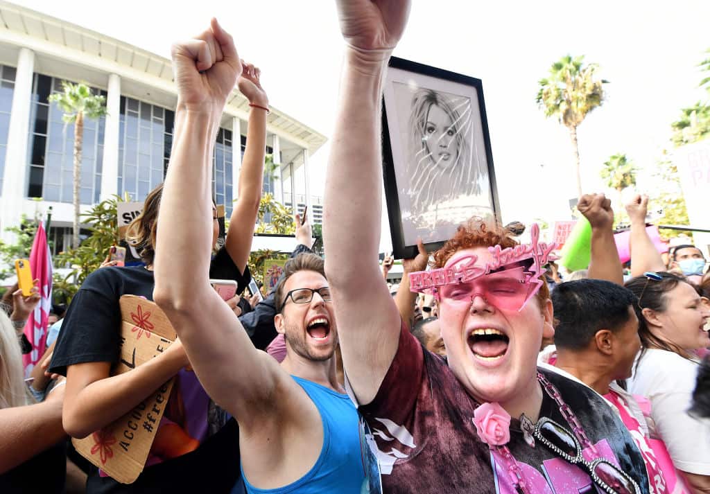 Britney Spears fan that goes by the name Jakeyonce, right, celebrates outside the courtroom after the court ruling.