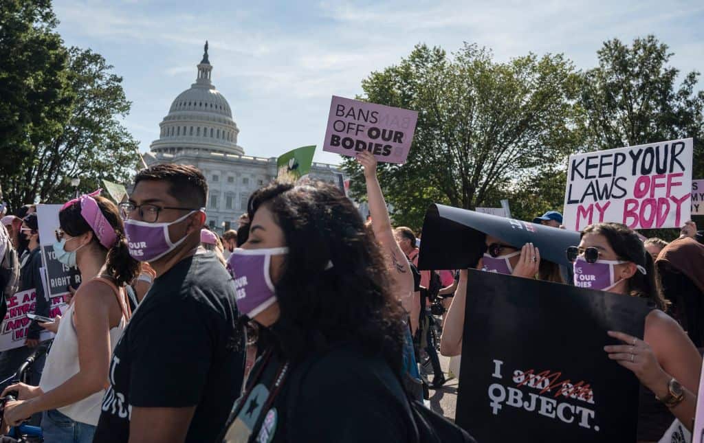 Protesters march past the US Capitol as they take part in the Women's March and Rally for Abortion Justice in Washington, DC, on 2 October 2021.