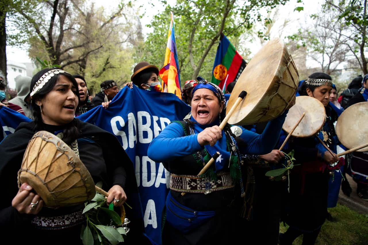 Mapuche Indigenous people protest in downtown Santiago, on October 10, 2021, amid the commemoration of the Day of the Race.