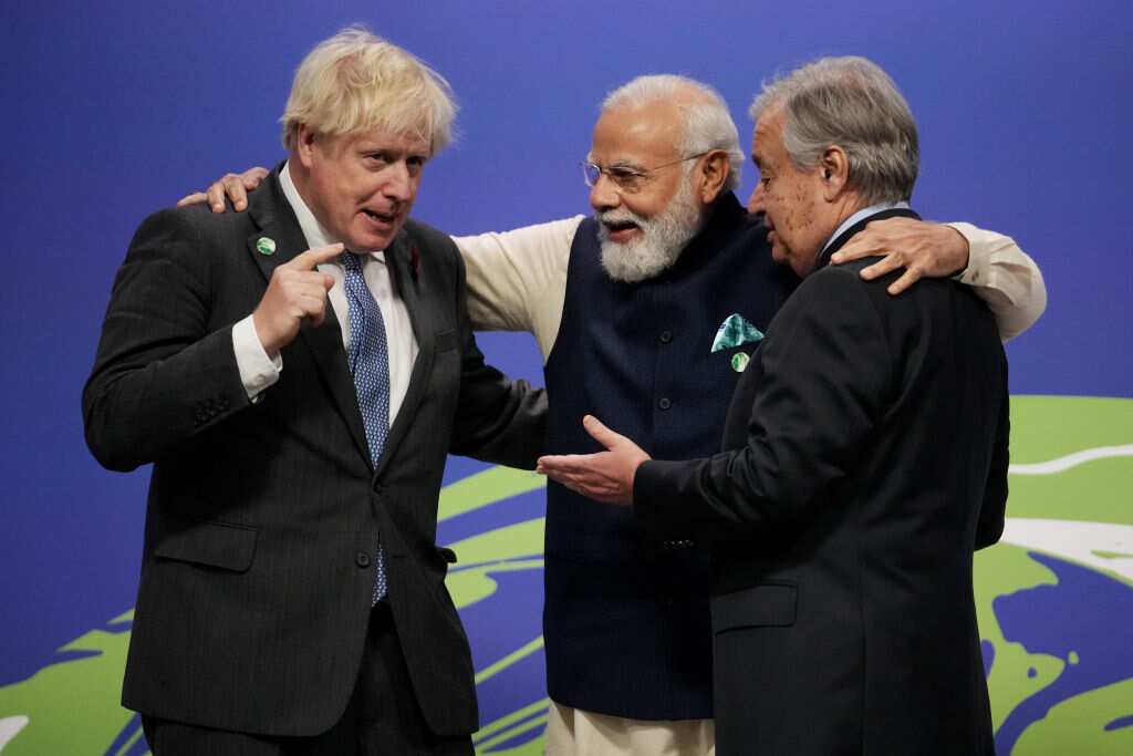 British PM Boris Johnson (L) and UN Secretary-General Antonio Guterres (R) greet Indian Prime Minister Narendra Modi as they arrive for day two of COP26.